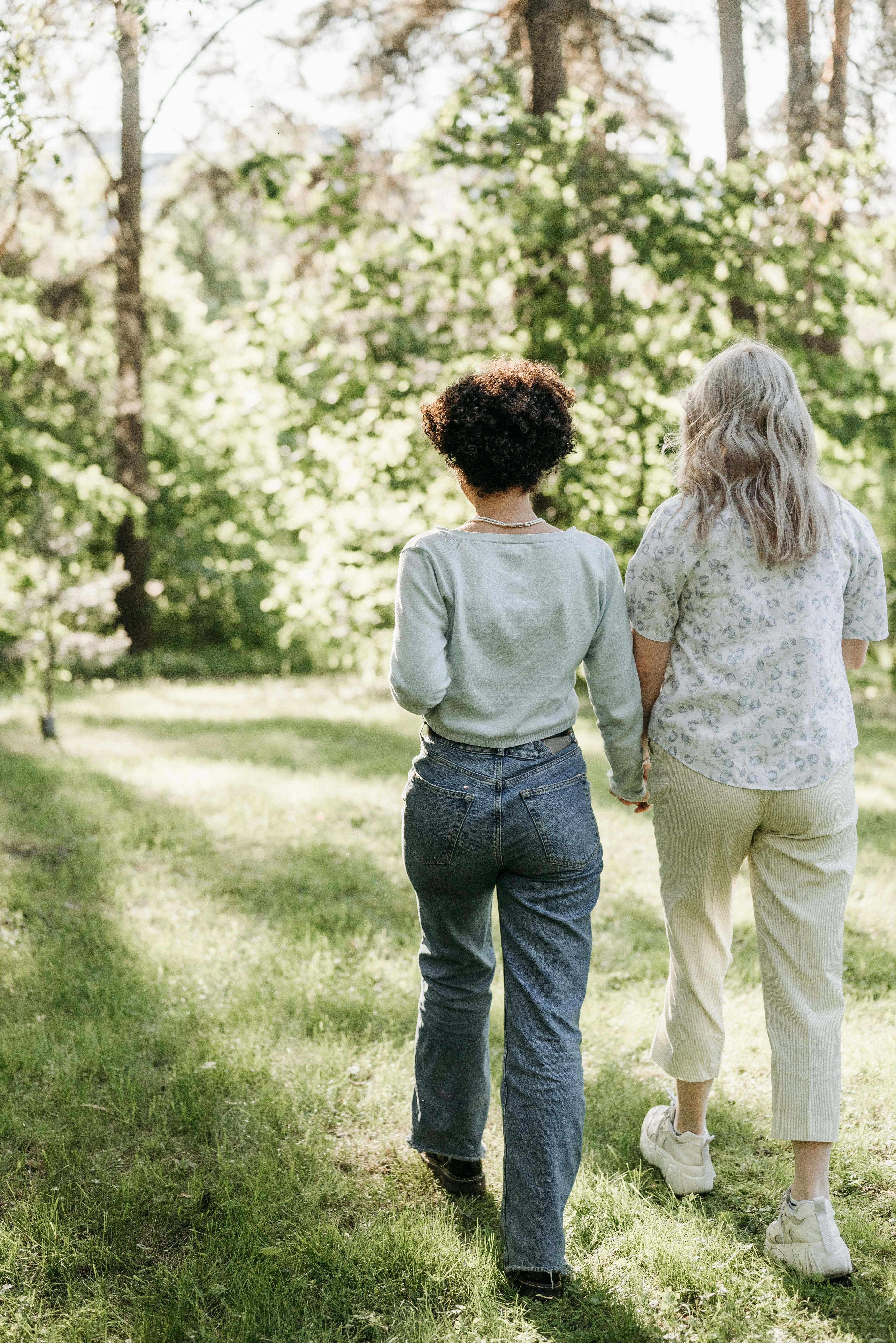 Two figures walking together through a forest — companionship through transition.